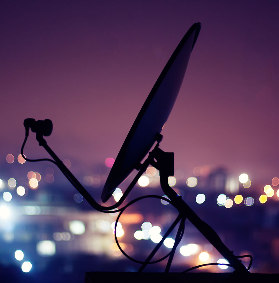 Satellite dish against the Riyadh skyline at dusk